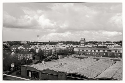 Buildings against cloudy sky