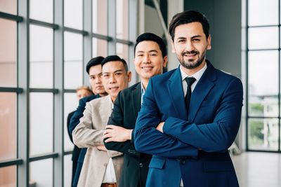 Portrait of businessmen shaking hands in office