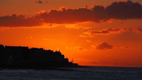 Scenic view of sea against orange sky