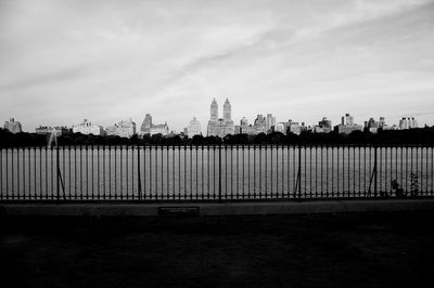 View of cityscape against cloudy sky