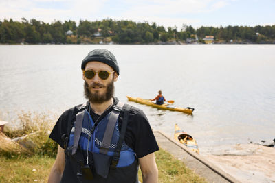 Man wearing life jacket walking at coast