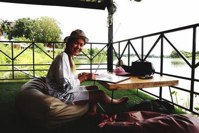 Young woman sitting on table