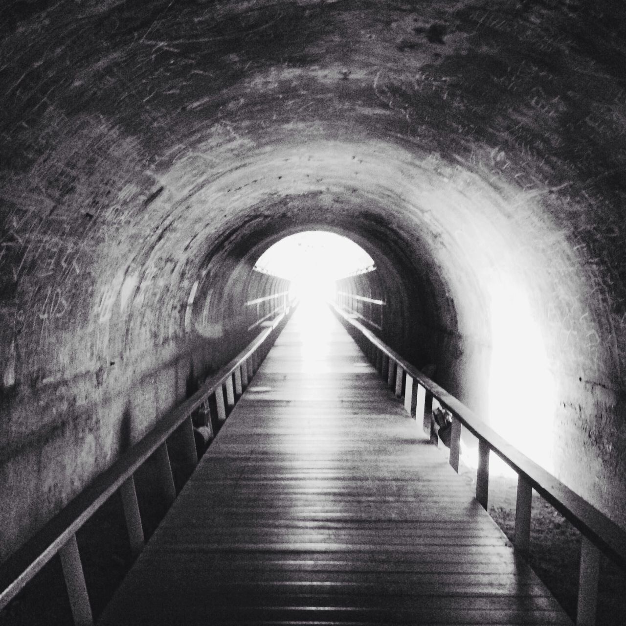 the way forward, tunnel, diminishing perspective, arch, indoors, built structure, architecture, vanishing point, narrow, railing, wall - building feature, empty, walkway, light at the end of the tunnel, no people, long, corridor, absence, day, connection