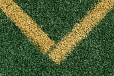 High angle view of yellow yard line on soccer field