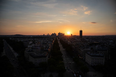 High angle view of buildings in city during sunset