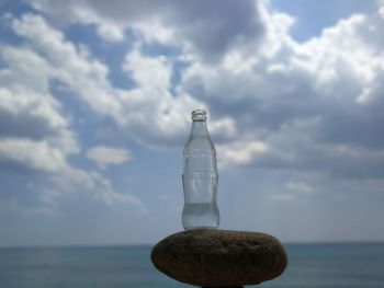 Water bottle on beach against sky