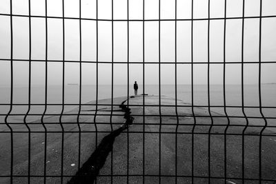 Full length of woman standing on pier against sea