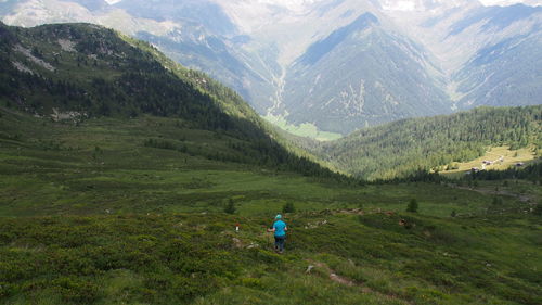 Man standing on field against mountains