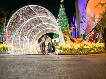 People in illuminated traditional clothing