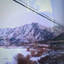 Scenic view of snow covered mountains against sky