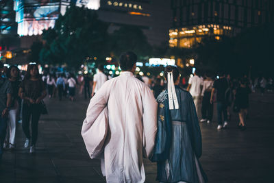 People walking on street at night