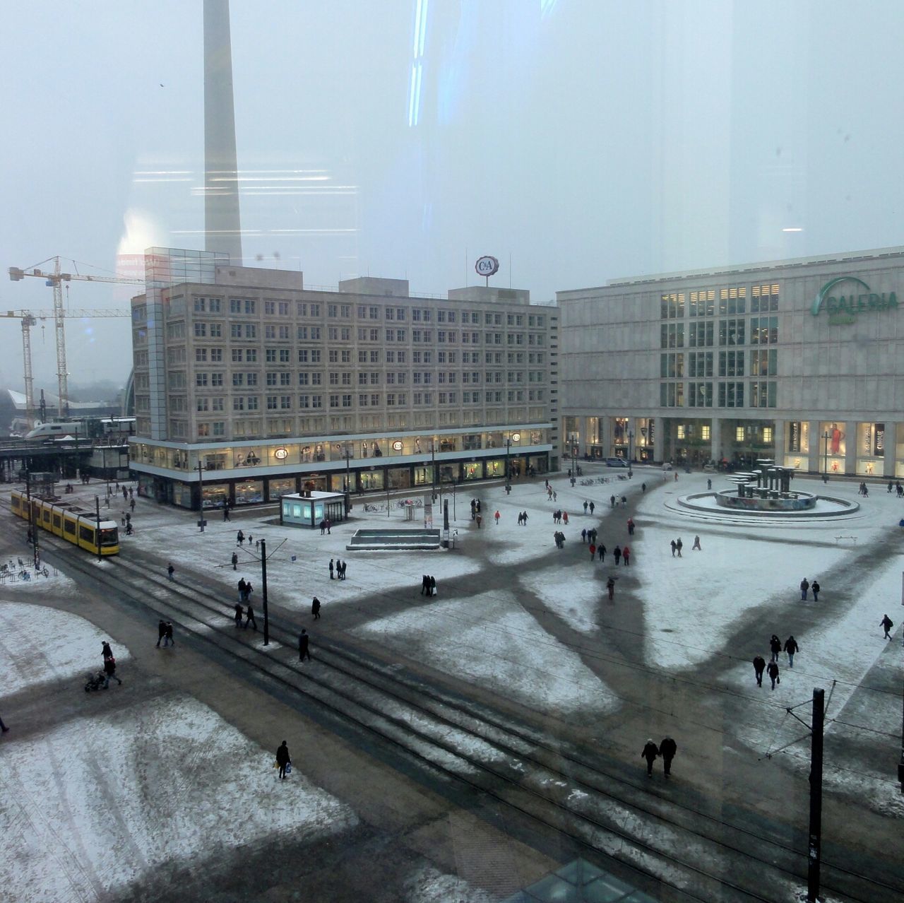 architecture, built structure, building exterior, city, transportation, large group of people, city life, public transportation, railroad station, incidental people, travel, mode of transport, railroad station platform, railroad track, high angle view, person, day, street, city street