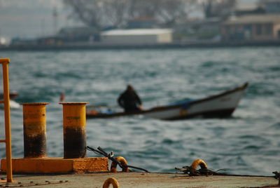 Close-up of boats in sea against the sky