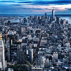 Aerial view of modern buildings in city against sky