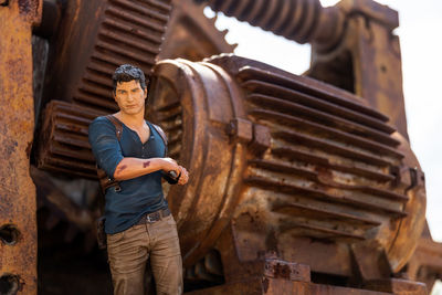 Portrait of young man working on wood