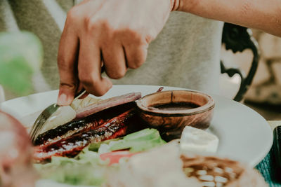 Midsection of person preparing food on table