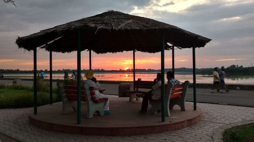 Chairs against sky during sunset