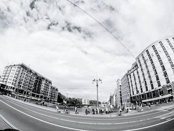 View of city street against cloudy sky