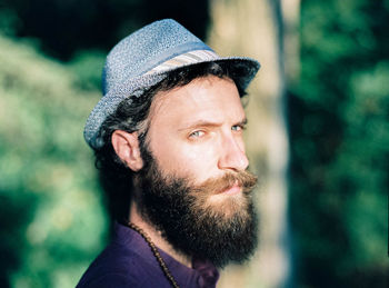 Close-up portrait of bearded man wearing hat