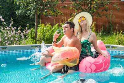 Woman sitting in swimming pool