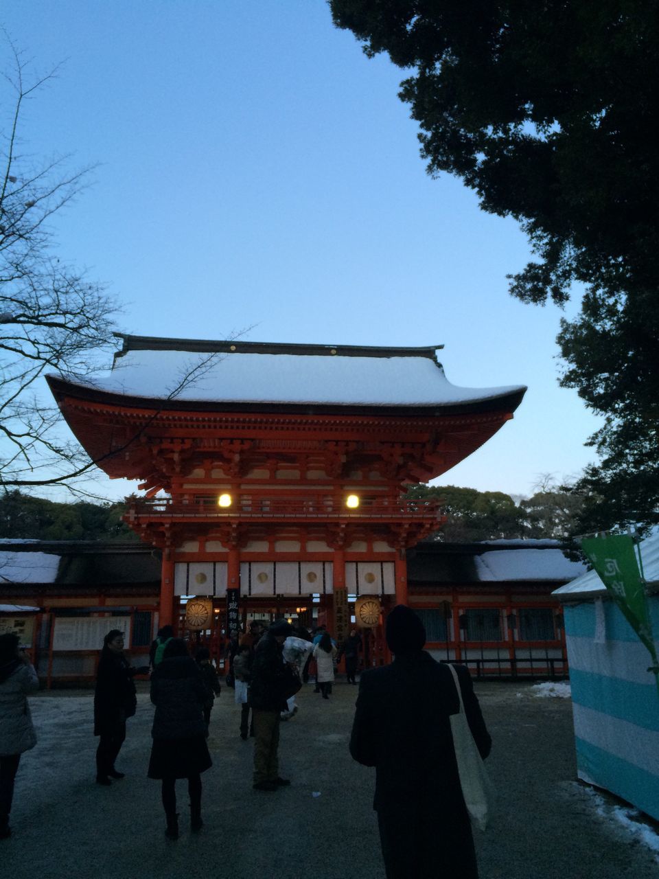 architecture, built structure, person, lifestyles, building exterior, men, walking, leisure activity, large group of people, clear sky, tree, place of worship, sky, street, religion, city life, outdoors, tourist, illuminated