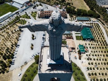 Statue in city against sky