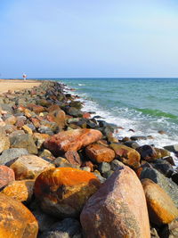 Rocks on beach against sky