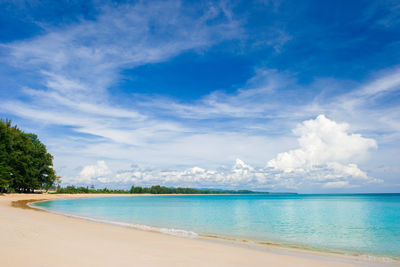 Scenic view of beach against blue sky