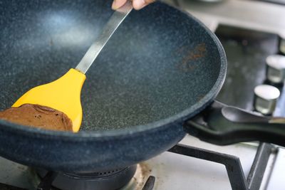 Midsection of person preparing food in kitchen