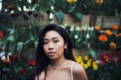 Portrait of young woman against blurred background