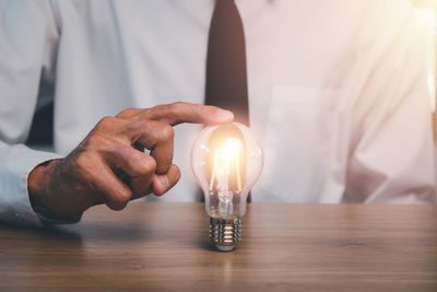 Close-up of light bulb on table