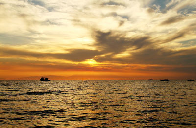 Scenic view of sea against orange sky