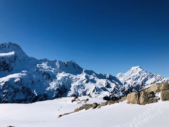 Scenic view of snowcapped mountains against clear blue sky