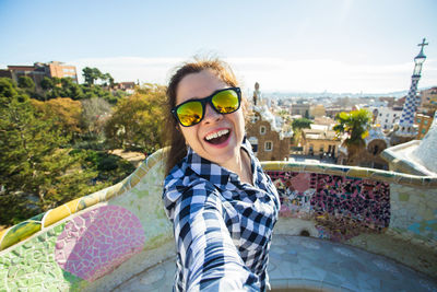 Portrait of smiling young woman wearing sunglasses