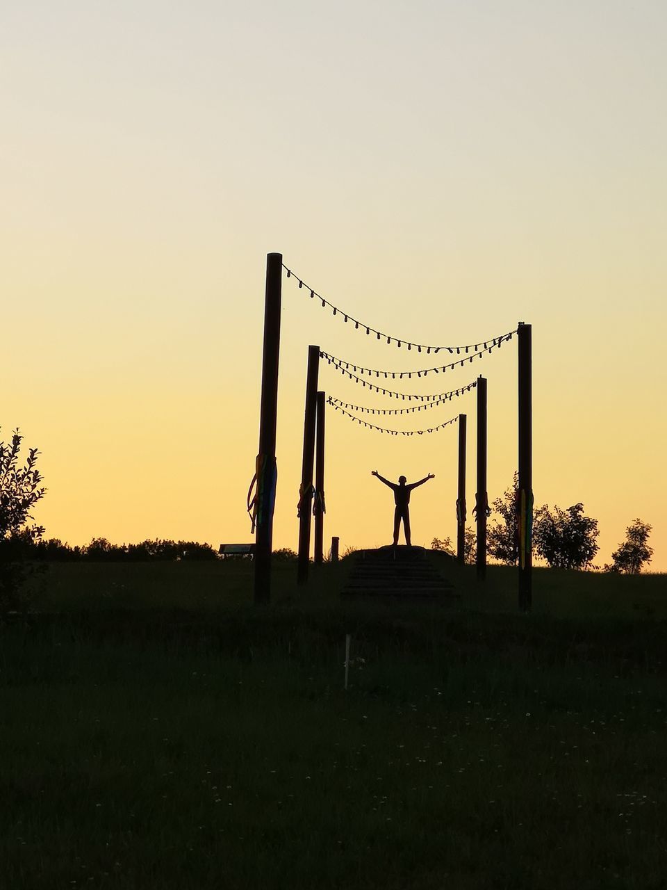 SILHOUETTE PEOPLE STANDING ON FIELD AGAINST SKY DURING SUNSET