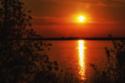 Scenic view of sea against orange sky