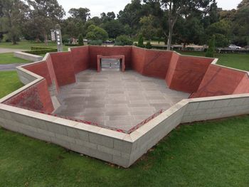 Empty park bench on field