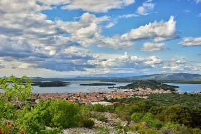 Scenic view of sea and mountains against sky