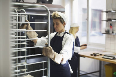 Female baker working in kitchen at bakery