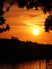 Scenic view of lake against orange sky