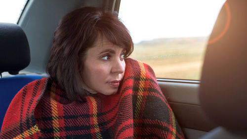 Portrait of woman sitting in car