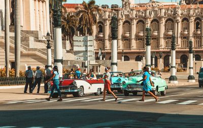 Group of people on street against buildings