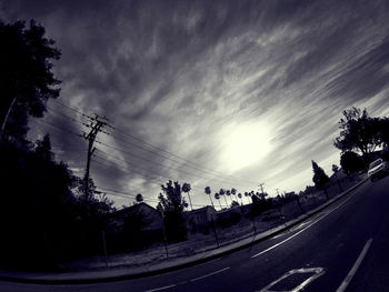 Road against cloudy sky at sunset