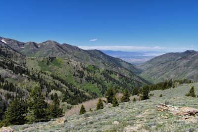 Scenic view of mountains against blue sky