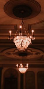 Low angle view of illuminated pendant lights hanging from ceiling