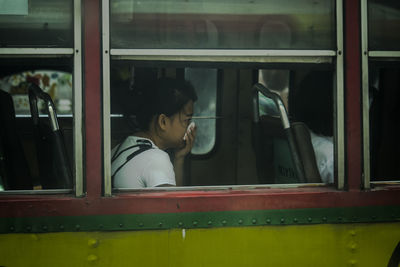 Side view woman sitting in bus