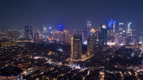 Aerial view of illuminated buildings in city at night