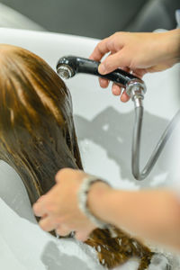 Close-up of person washing hair