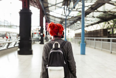 Rear view of woman standing in city
