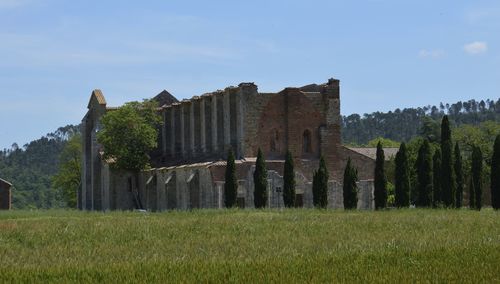 Built structure on field against sky